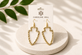 Ciara Hammered Arrowhead Earrings in gold on Caroline Hill display card