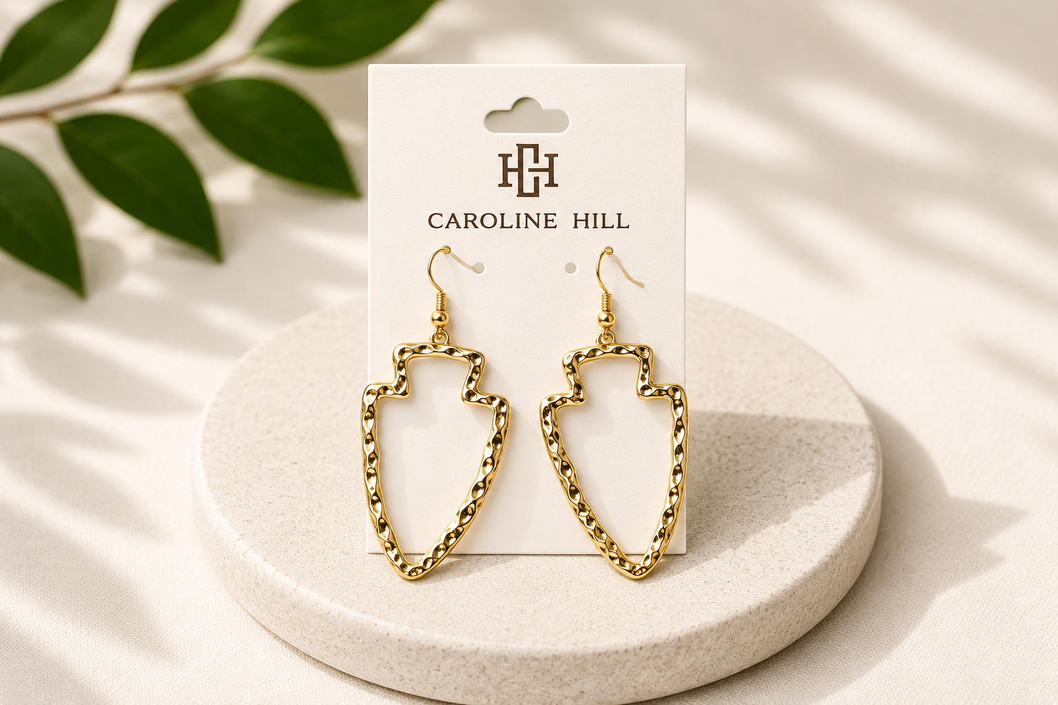 Ciara Hammered Arrowhead Earrings in gold on Caroline Hill display card